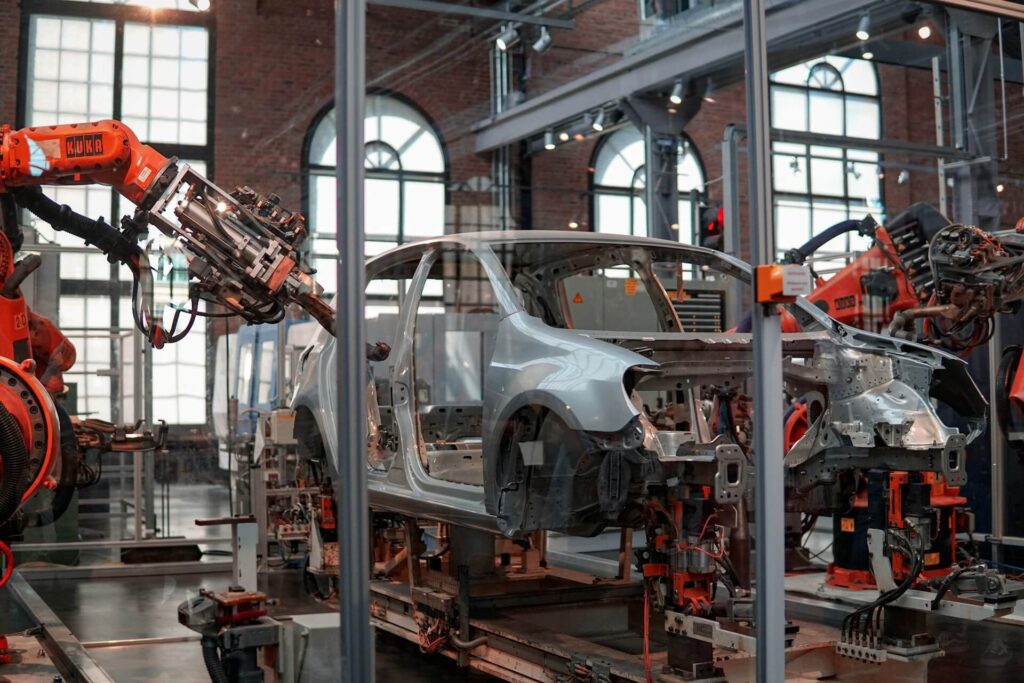 A vehicle being fixed inside a factory using robots